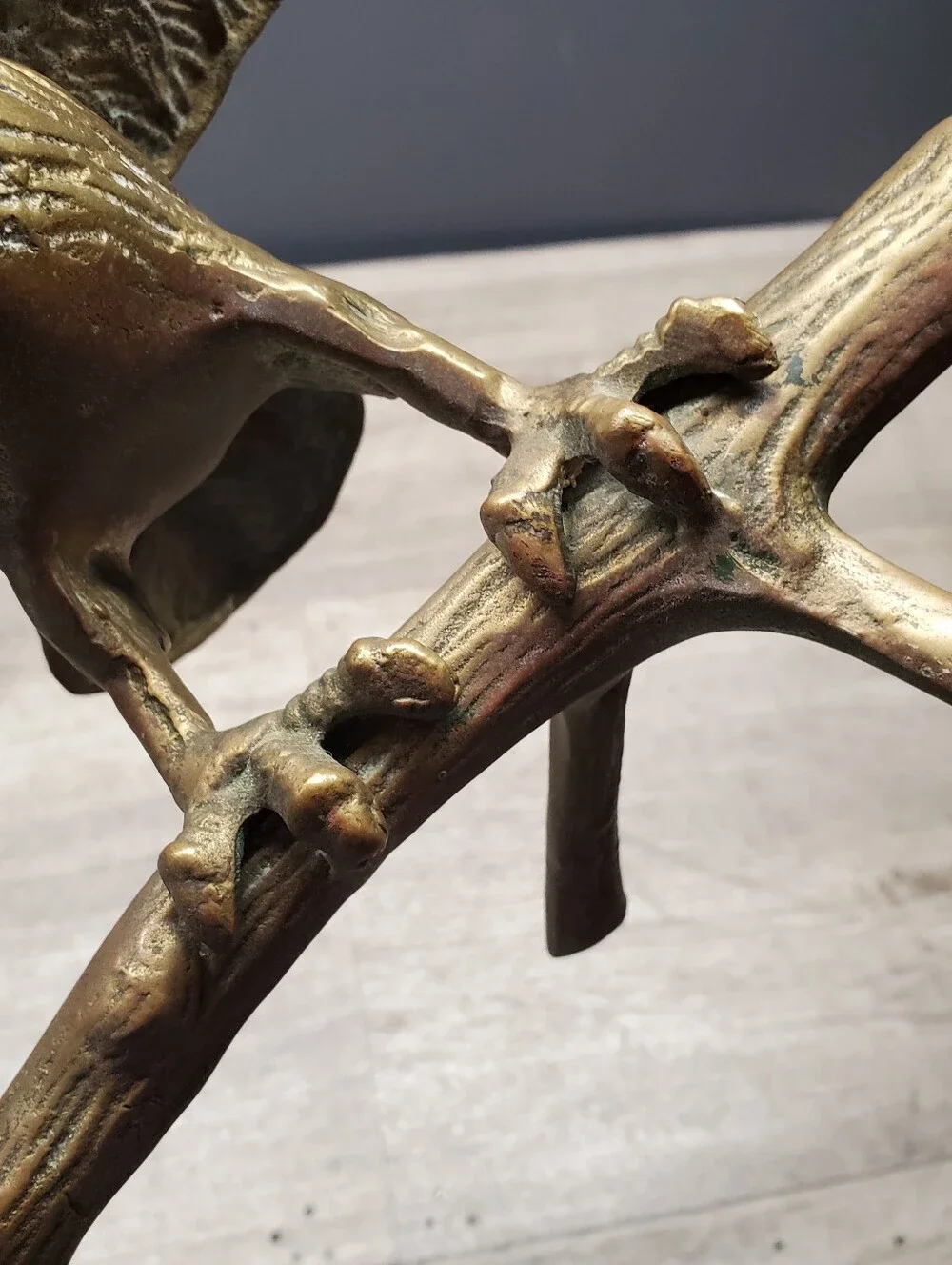 Vintage brass eagle statue perched on a tree branch